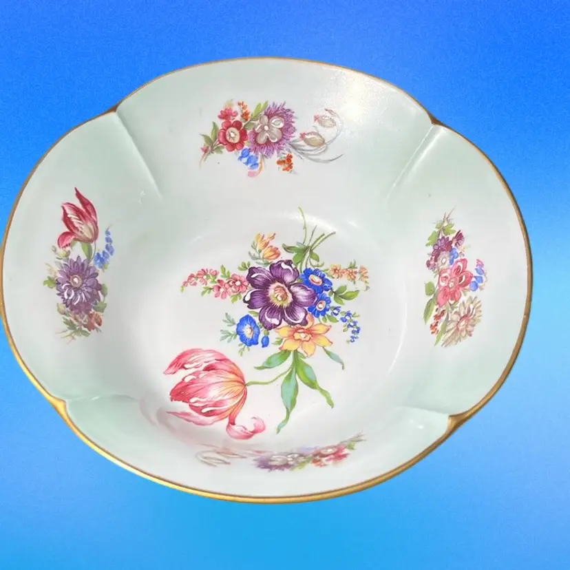 Antique Limoges porcelain compote with hand-painted floral motifs and gilt rim.