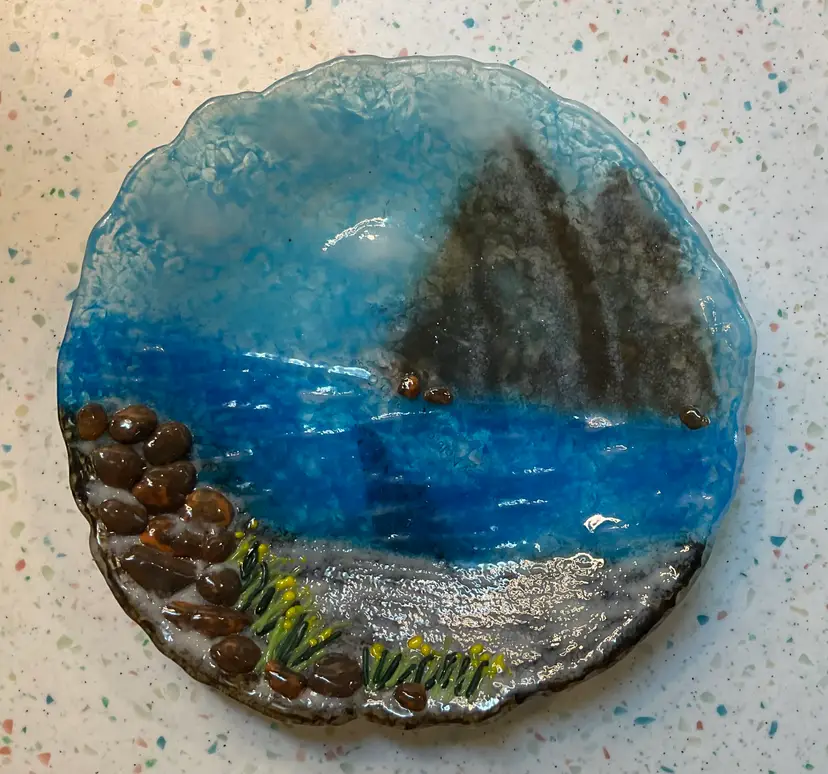 #01 Fused glass dish with 3d effect using pebbles on beach. Dish is 8 1/2” round and 1” tall.  Business cards still attached states Glass designs by Janien