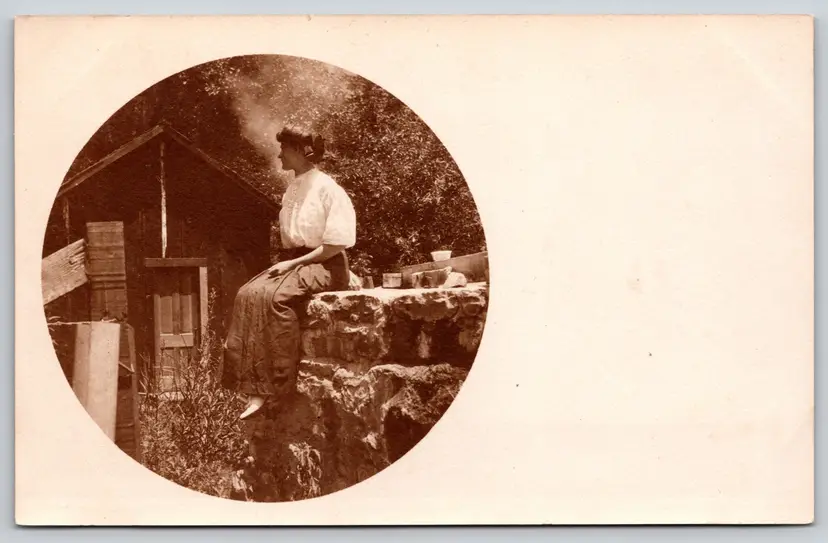 Postcard RPPC Young Woman Sitting on Stone Wall Real Photo Round Vignette - 9130