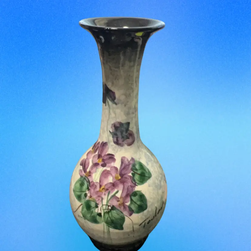 vintage French ceramic vase from Toulon features a distinctive blue-and-white mottled finish with painted purple floral details Signed