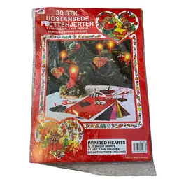 This is a Pobra Heart Basket Paper Kit (No. 6506), which provides pre-cut sheets to make traditional Danish woven hearts (julehjerter). 
The kit includes 30 push-out hearts in 3 sizes and 8 assorted colors.
Danish woven hearts are a traditional Christmas ornament, also popular for Valentine's Day