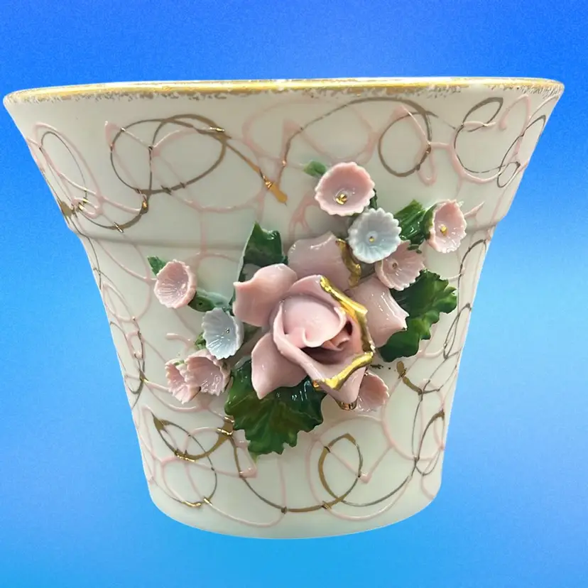 This is a vintage Lefton porcelain planter with applied flowers.