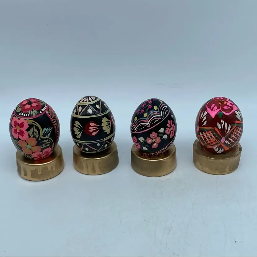 #2926 Set of four hand-painted Ukrainian wooden pysanky eggs with floral and geometric designs.