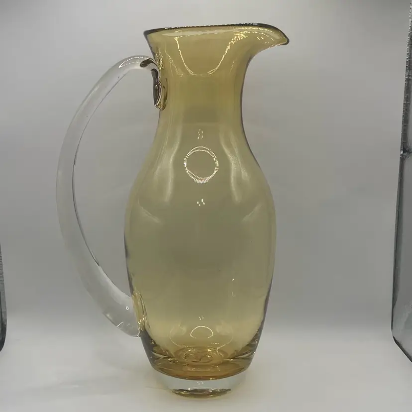 11 1/2” Tall Yellow Hand Blown With Clear Applied Handle Glass Pitcher, Unsigned