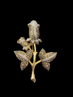 vintage gold-toned damascene-style floral brooch with a faux pearl cente