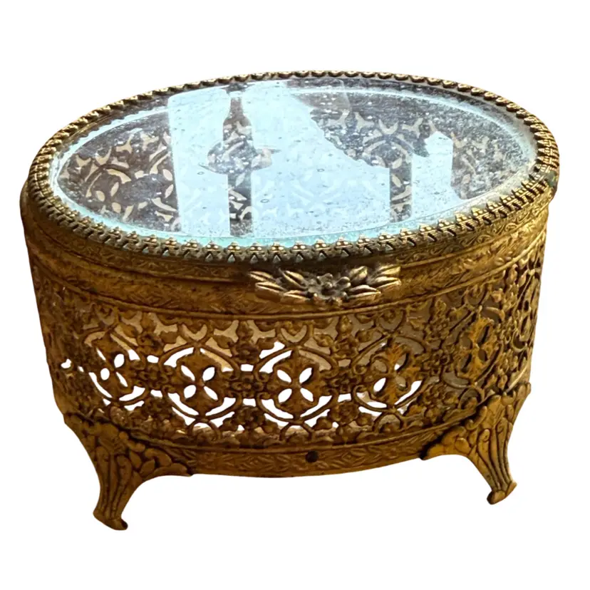 vintage gold filigree ormolu jewelry trinket box with a beveled glass lid