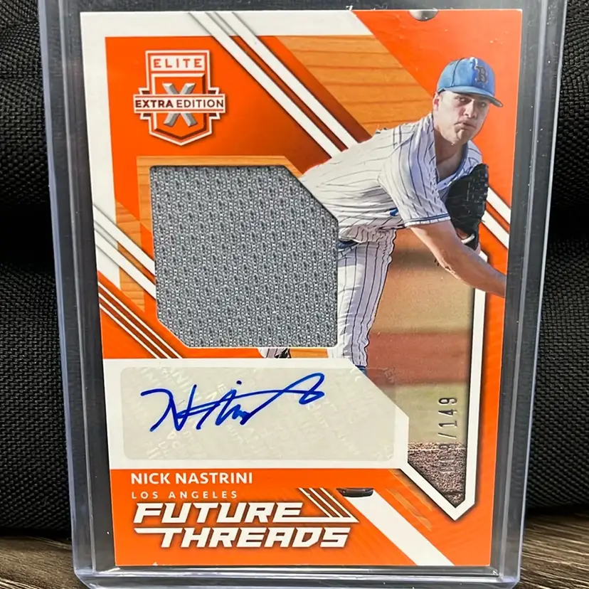 2021 Panini Elite Extra Edition Future Threads Signatures Nick Nastrini. Orange parallel version, serial-numbered to 149 copies, and includes an authentic autograph and a game-used or player-worn memorabilia patch.