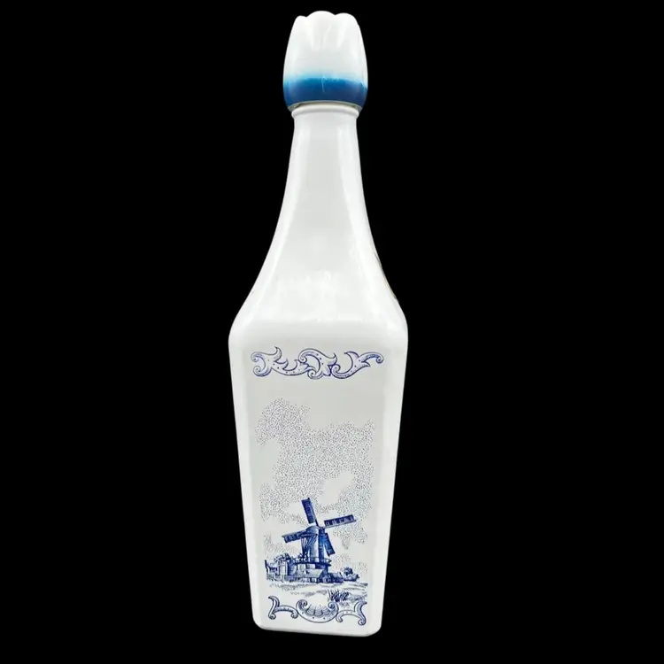 #244B Vintage Vandermint Minted Chocolate Liqueur Bottle. Empty.  Bottle is White with Blue Illustration Featuring Dutch Windmill and Countryside and has a Tulip Shaped Stopper/Lid Imported from Holland