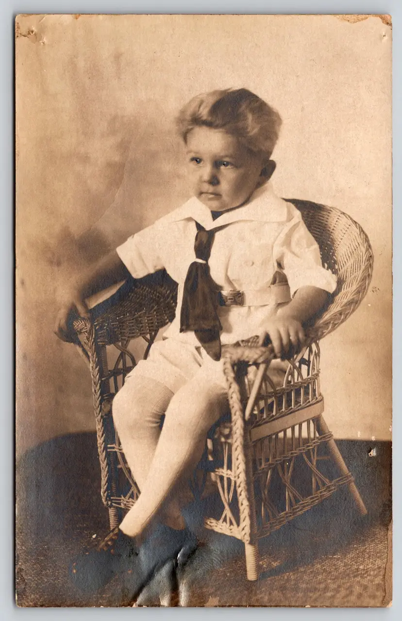 Postcard RPPC Boy with Full Hair Sitting on Wicker Chair Real Photo Belt Buckle - 9394