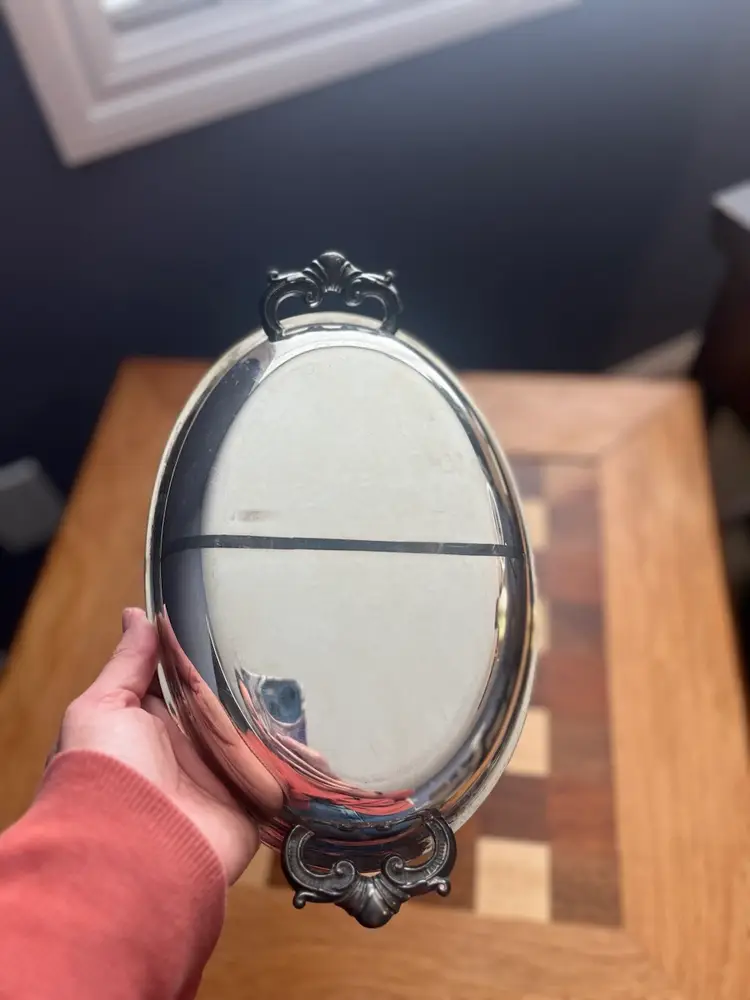 #01 Vintage stainless steel oval serving tray with ornate handles.