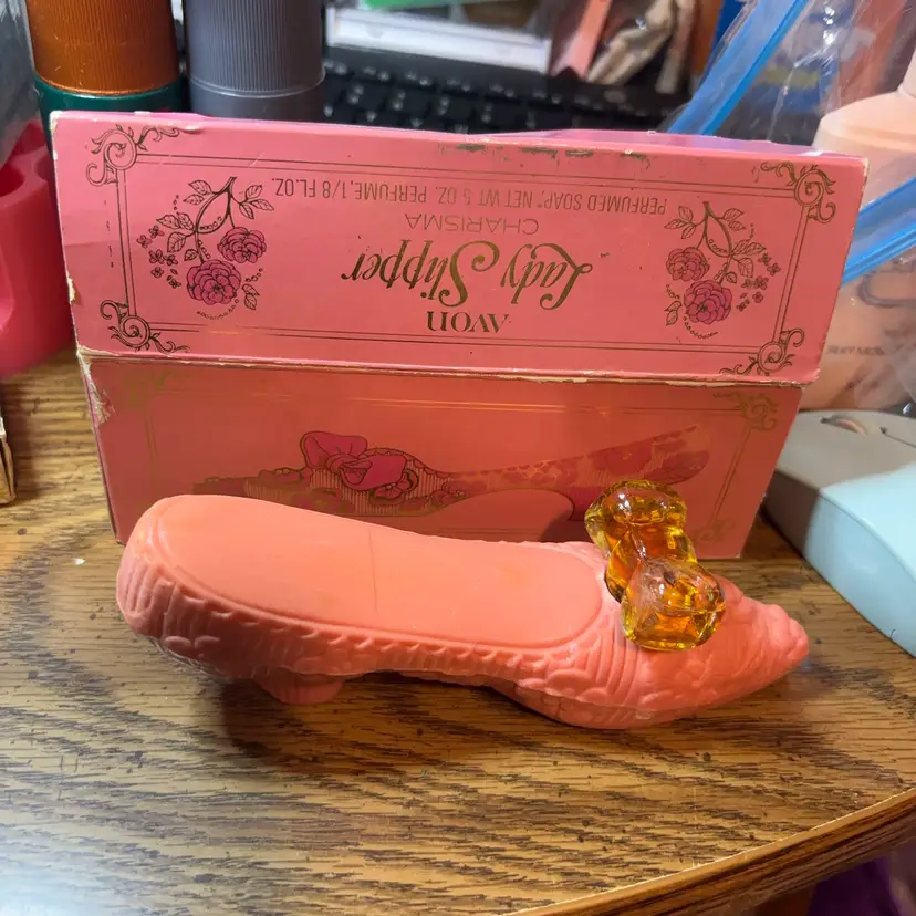 This is a vintage 1972 Avon "Lady Slipper" perfumed soap set.The set includes a 5-ounce, pink slipper-shaped soap and a 1/8 fl oz bottle of Charisma perfume shaped like a bow.The product comes in a decorative pink box featuring rose Msrp $20