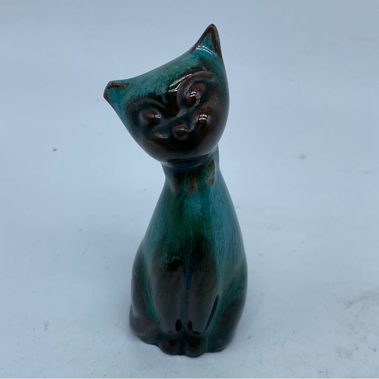 A Blue Mountain Pottery stylized cat figurine with green and black drip glaze.