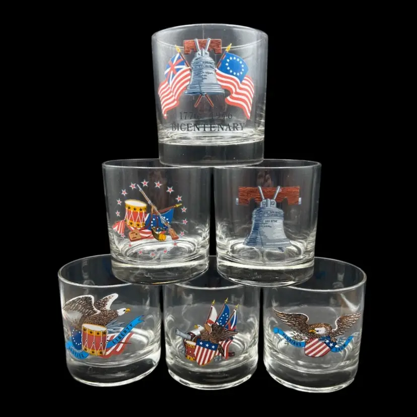 #236A Vintage 1976 American Bicentennial Rocks Glasses, Manufactured  by the West Virginia Glass Specialty Company. 
Each glass features patriotic graphics celebrating the 200th anniversary of the United States (1776–1976),  
Liberty Bell, American Flags, and Eagles
One Glass Has A Rim Chip - See Pictures For Details