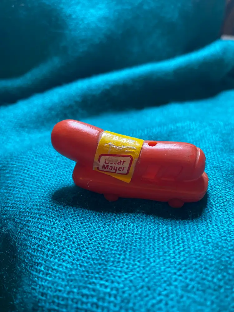 Oscar Meyer Weenie Whistle. Very well loved as you can see in the pictures. It’s a whole 2.25 inches long. Just like the one in the movie The Santa Clause.