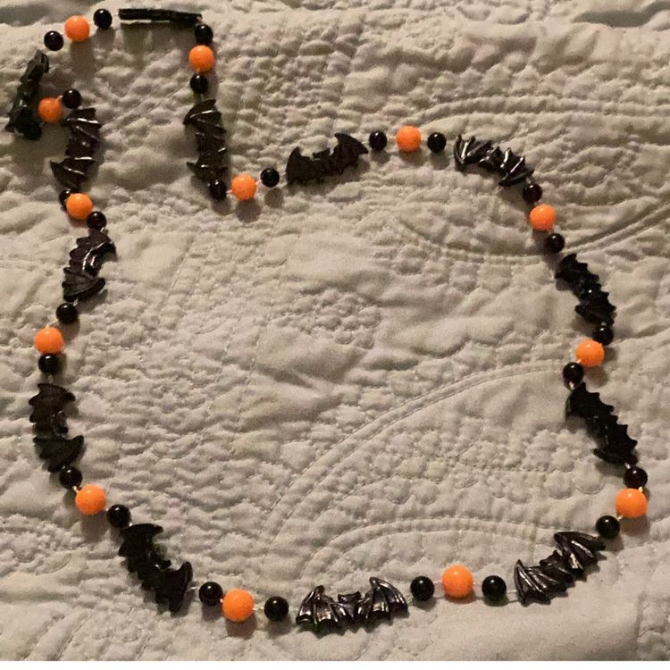 Halloween necklace, black bats, and orange beads can be turned into a bracelet
