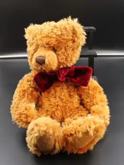 “Timber” by Russ Berrie with red velvet neck bow. 12 inches long.