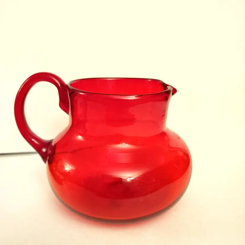 Ruby red hand blown art glass pitcher. Pontil mark. Made in Mexico. 4.5 high.