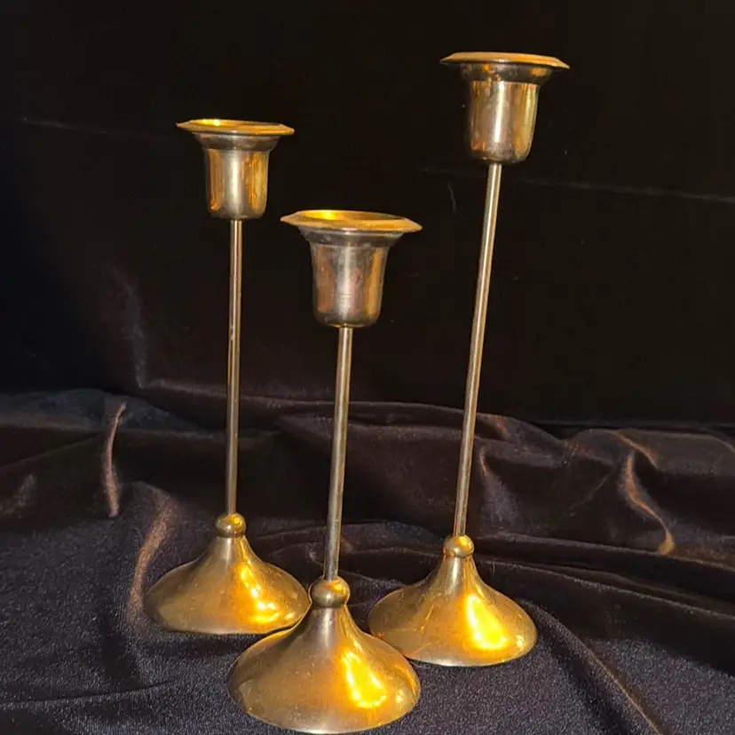 Three Vintage Brass candlestick holders. One each 6.5,7.5,8.5 inches. Made in India