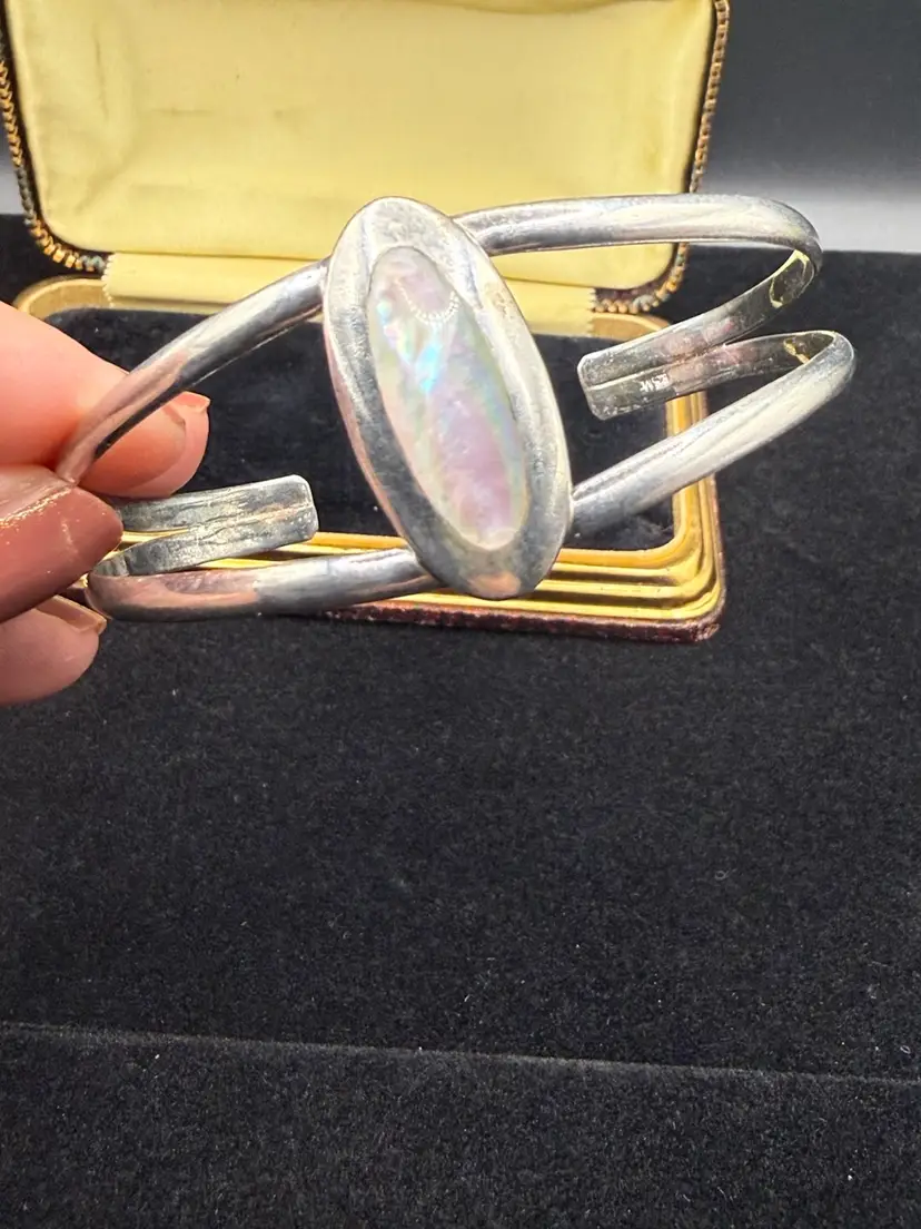 vintage sterling silver cuff bracelet with an oval opal stone setting.