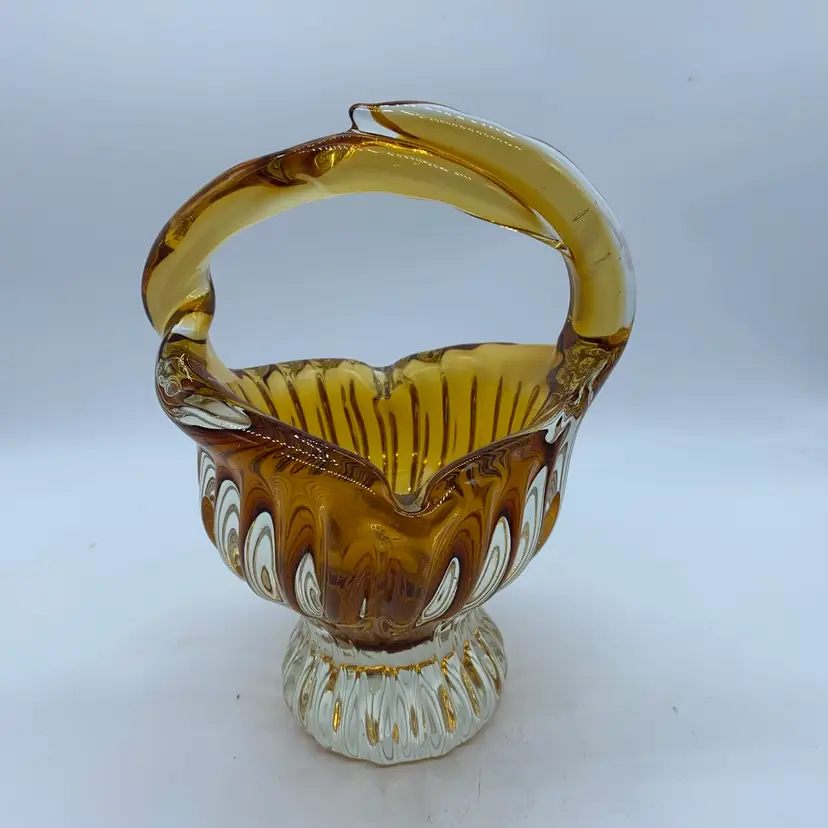 #1100 High Quality art glass basket with amber swirls and a polished clear base.