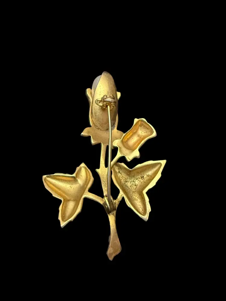 vintage gold-toned damascene-style floral brooch with a faux pearl cente
