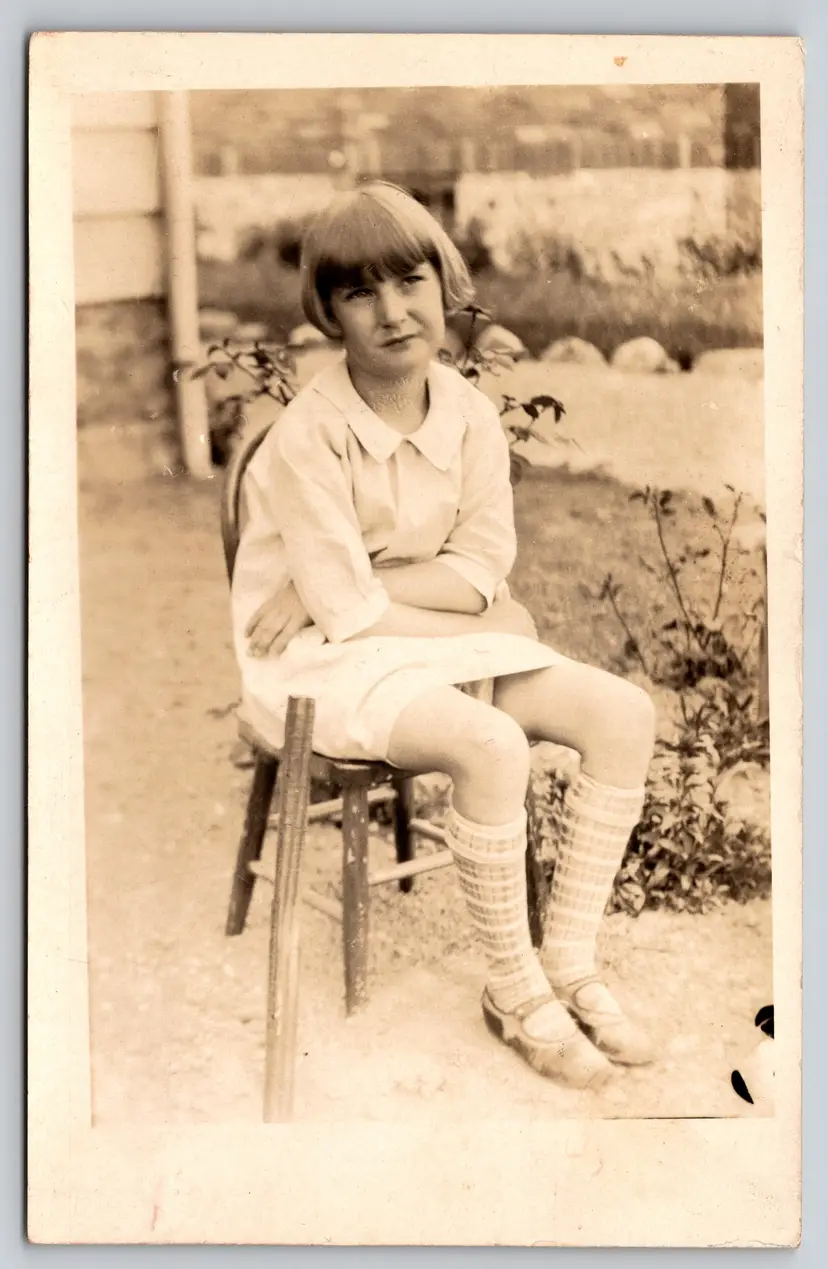 Postcard RPPC Young Girl Seated on Chair in Garden Real Photo Bangs - 8884