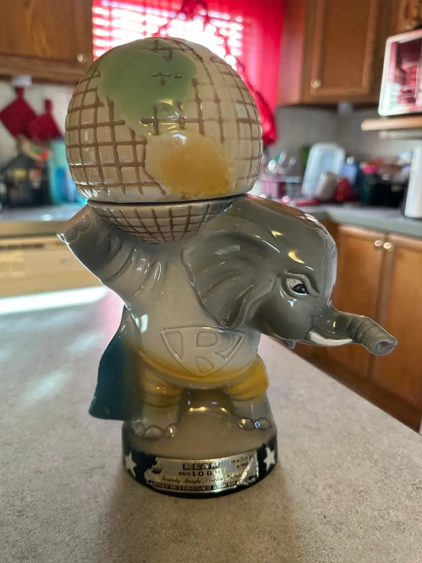 Ceramic whiskey decanter in the form of an elephant with a world globe, by Jim Beam. Rare. Approximately 11x6x6”