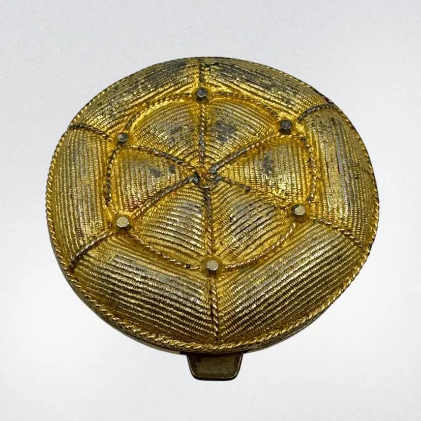 Vintage Max Factor "Persian Pillow" compact with woven gold-tone design.