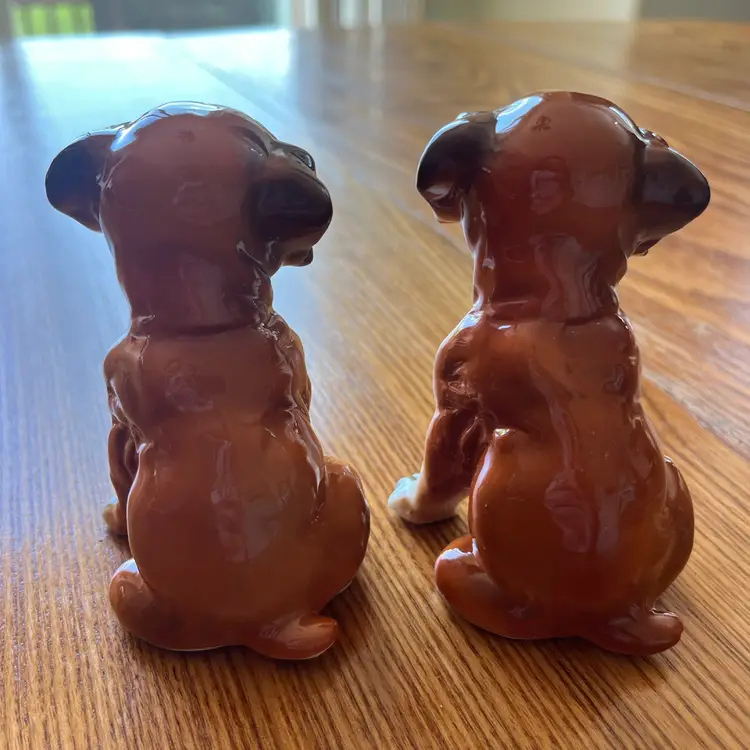 A pair of vintage ceramic boxer puppy figurines. 4” Tall