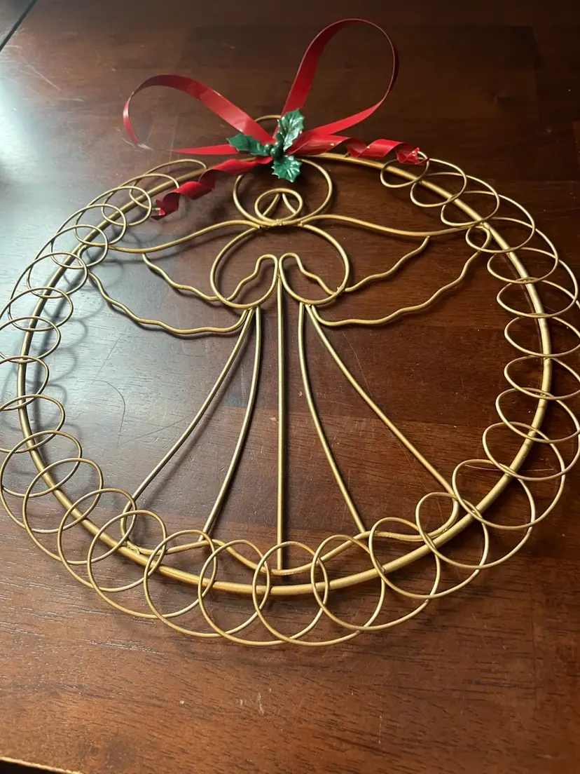Gold-toned wire angel wreath Christmas card holder with red ribbon. 13”