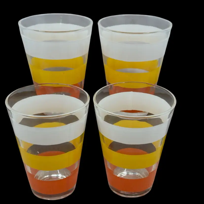 Set of four vintage Juice tumblers with white, yellow, and orange stripes, 1970’s