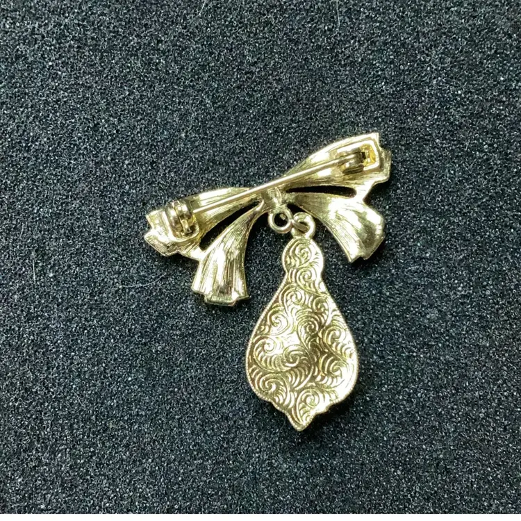 1928 Gold Tone Bow Brooch Purple Glass Drop With Rhinestones