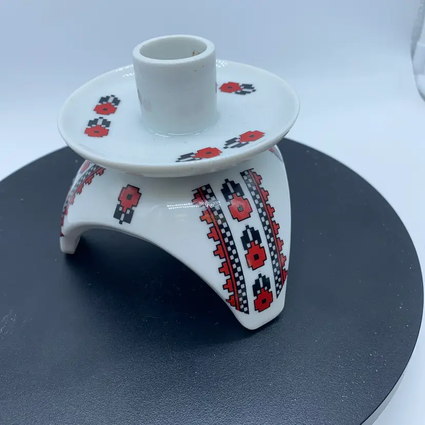 #3412 White ceramic candle holder with red and black Ukrainian folk art motifs.
