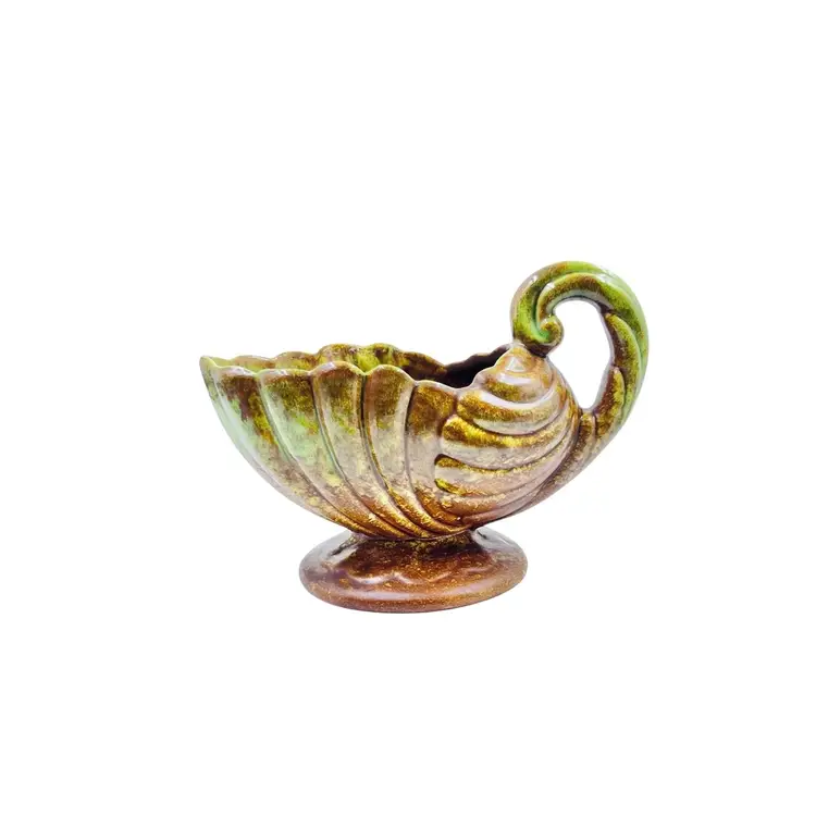 FOOTED GRAVY BOAT SERVER
By Heager Pottery USA
1940-50
Holiday Hosting 

Shell Shape 
Twist Handle 
Brown Green Glaze

Fall Autumn Harvest Thanksgiving 
Halloween Christmas Party Celebration Gift Planter