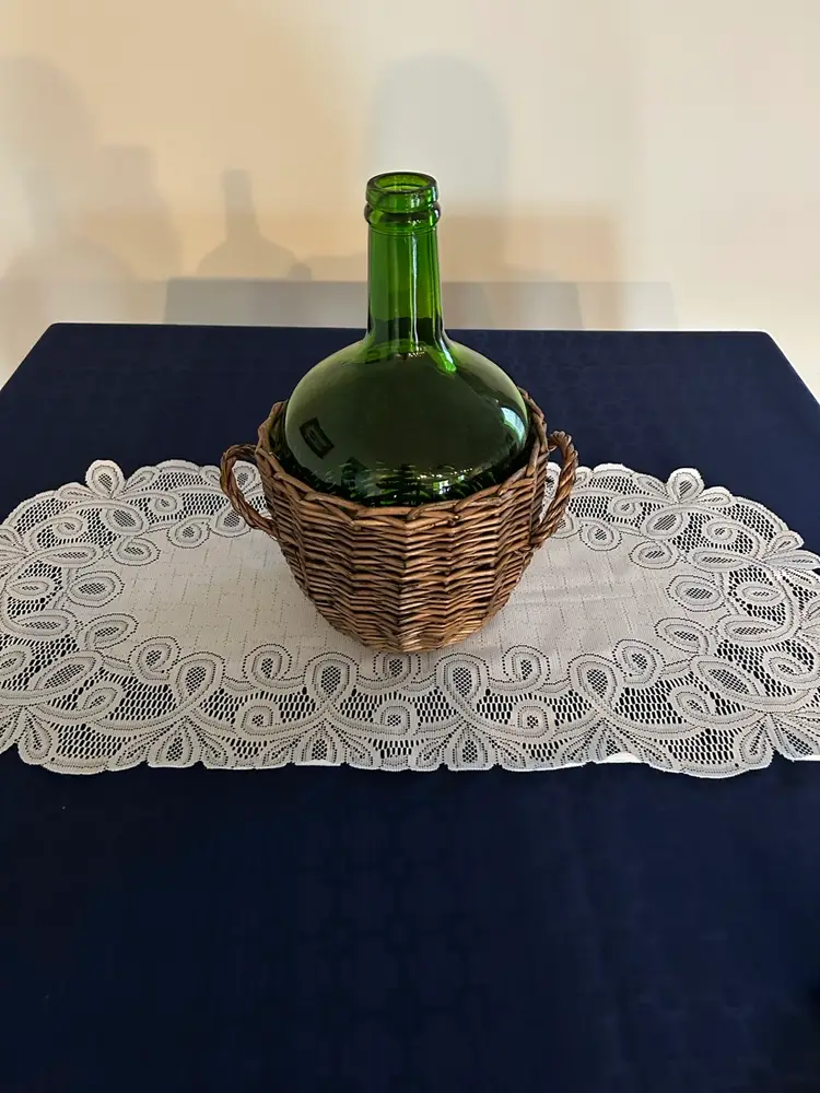 Vintage emerald green glass Demi John wine bottle with wicker basket