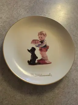 Porcelain collector plate titled
'Begging His Share' by M.I. Hummel for Goebel
