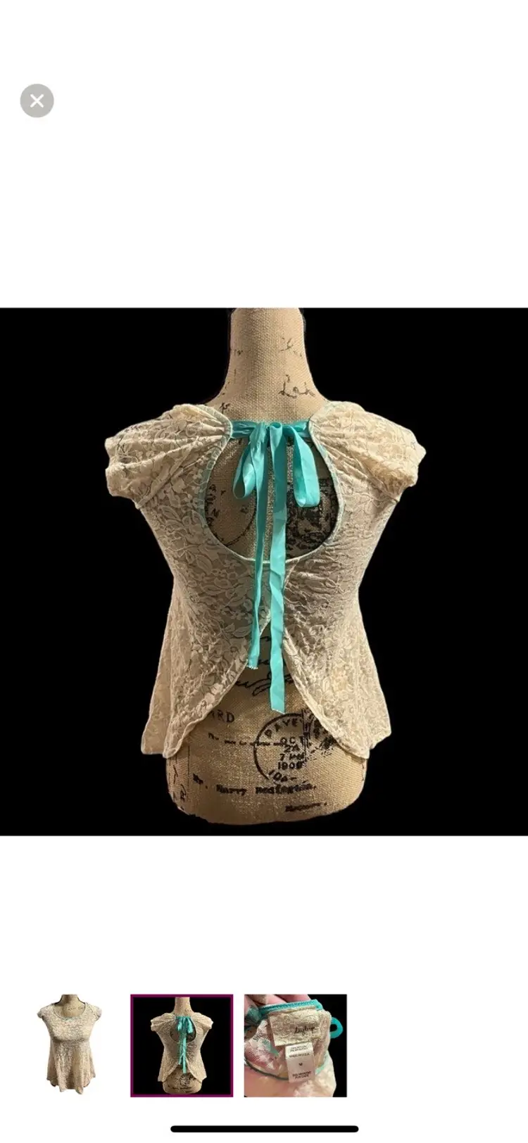 Day trip cream lace sheer top with teal ribbon ties on the back.