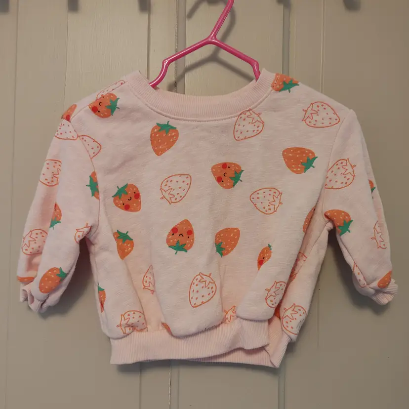 Kids Top- Brand: Old Navy. Size 3-6 months. Strawberry sweater. Material- 52% cotton, 48% polyester. No callouts.