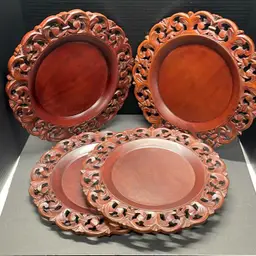 Pier 1 Imports dark brown hand-carved wooden charger plates. Set Of Four.