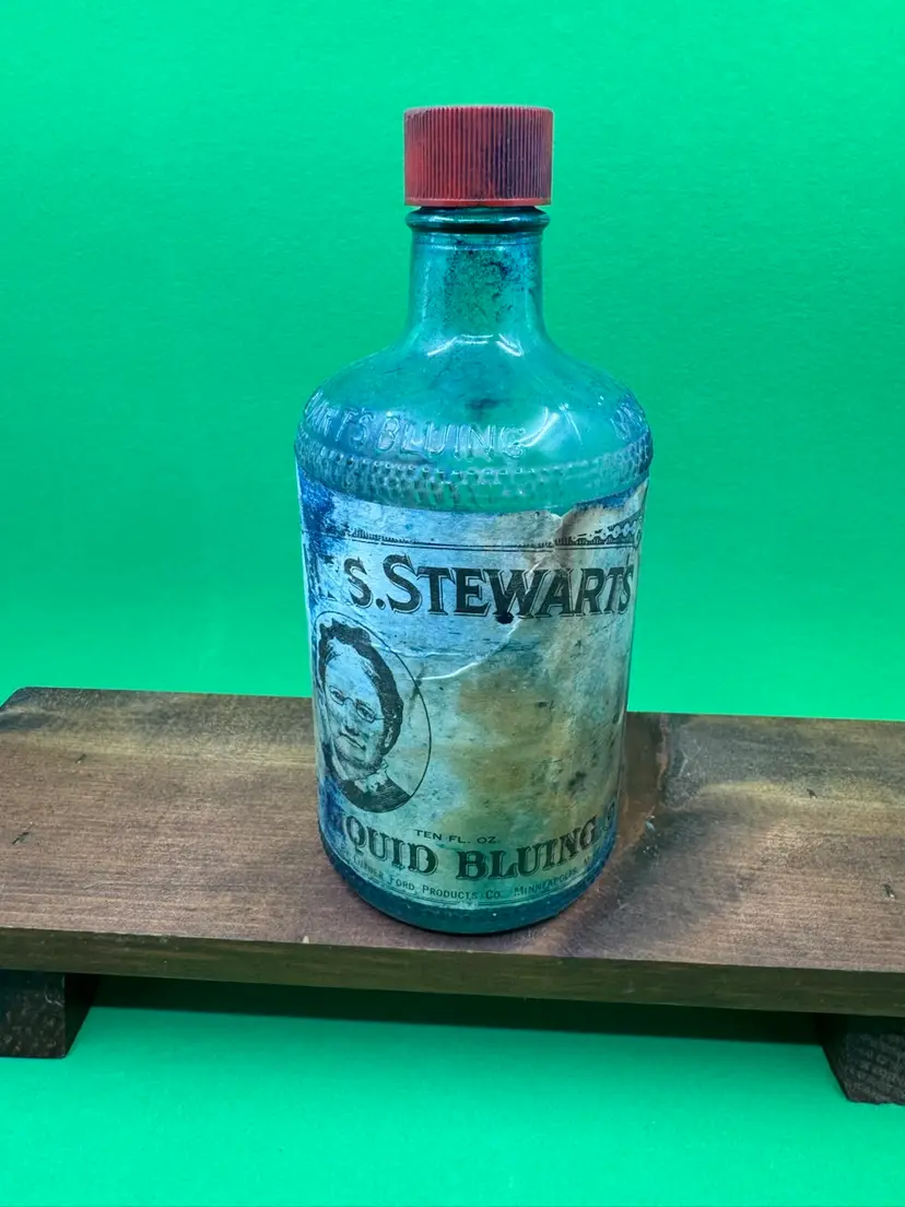 Vintage Mrs. Stewart's Liquid Bluing glass bottle with red cap, 6”