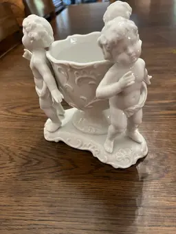 Candy dish with cherubs around it