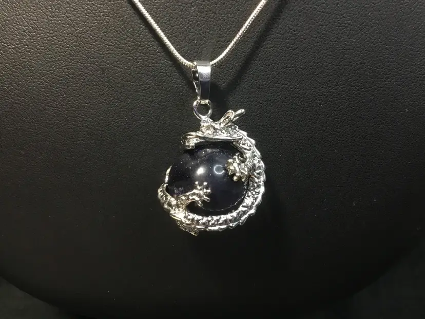 Necklace, silver tone dragon on dark blue, sparkly ball pendant, silver tone chain