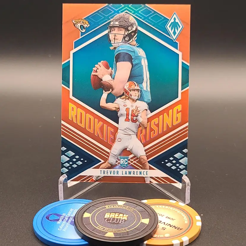 Trevor Lawrence Rookie 2021 Panini Phoenix Football Rookie Rising Insert Card Orange Parallel Numbered 56/99 Card #RIS-1 - Jacksonville Jaguars
