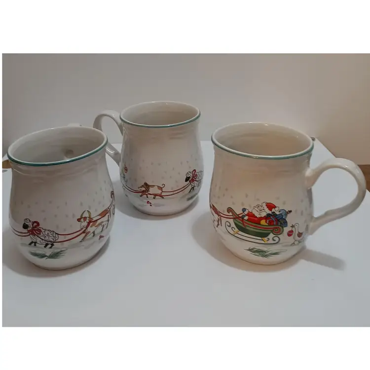 Santa's Sleigh Pulled By Farm Animals Adorns This Set Of 3 Ceramic Mugs; International Table Works