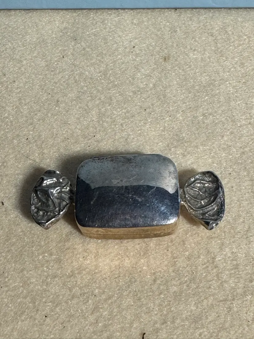 Vintage metal candy-shaped trinket box with embossed ends
