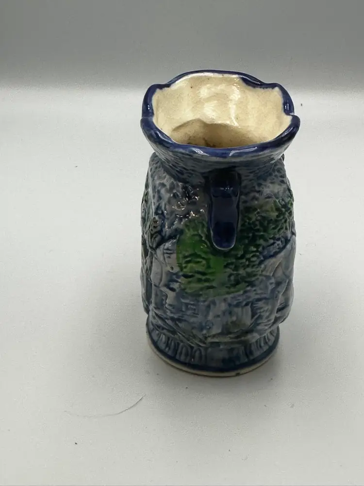 A14 A vintage Japanese porcelain vase with a raised hunting scene.