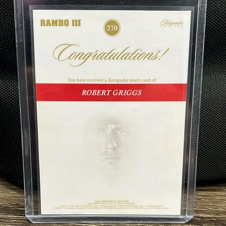 2024 Keepsake Collection Robert Griggs parallel trading card, Rambo franchise. Features an illustrated portrait of the character Robert Griggs, who appeared in the movie Rambo III.