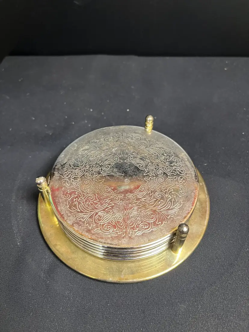 Set of 5 Silver Plated w/ Rubber Backed Coaster w/ Holder. Has Patina. Beautiful floral pattern. Lot 48
