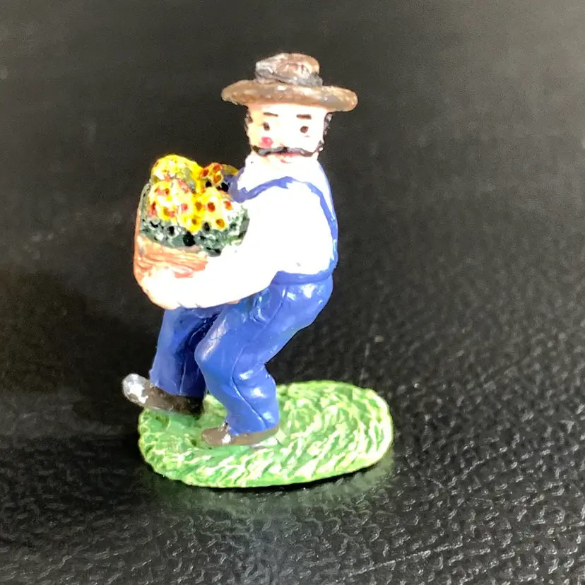 Tiny Metal Man Carrying Flowers