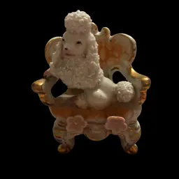 White Porcelain Spaghetti Poodle Figurine Sitting On An Elegant Gold Trimmed Chair